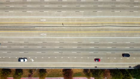 An-Aerial-view-of-light-flowing-traffic,-on-a-highway,-at-60-frames