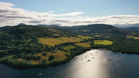 Aerial-Footage-Panning-from-Green-Scottish-Landscape-to-Urquhart-Castle-on-Loch-Ness,-Near-Inverness,-Scotland