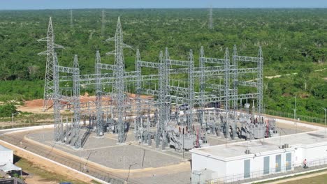 Drone-orbit-shot-of-electrical-substation-supply-solar-panels-in-scenic-area-of-Dominican-Republic---Electric-power-plant-park
