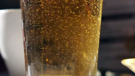 Super-Slow-Motion-Shot-of-Bubbling-Beer-in-Glass-with-Foam