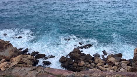 Slow-motion-view-of-waves-breaking-at-rocky-shoreline