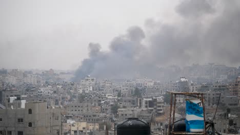 Smoke-rising-above-bombed-Gaza-city-center,-establishing-shot