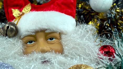X-mas-Santa-Claus-face-in-a-red-hat-with-bells,-big-white-beard,-Christmas-moving-decoration,-traditional-holiday-presents,-new-year-decor,-shiny-colorful-setup,-creative-close-up-shot,-4K-video