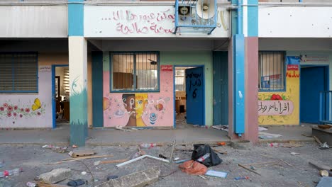 Moving-cautiously-through-scattered-debris-towards-colourful-Palestinian-classroom