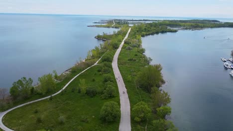 Aerial-shot-of-bike-path-surrounded-by-water---slow-push-in