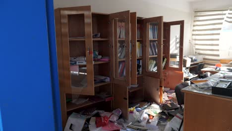 Office-with-personal-belongings-abandoned-during-war-in-Gaza,-establishing-shot