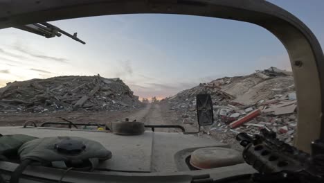 Driving-armored-vehicle-through-destroyed-Gaza-city-with-bombed-buildings-