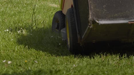 Lawn-Mower-Driving-On-Grass-In-The-Garden