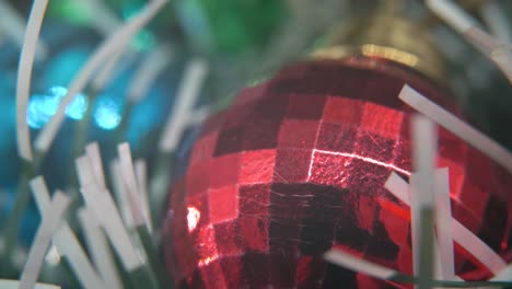 Christmas-decoration,-colorful-crystal-ornaments-blue,-green-and-red-balls,-new-year-decorated,-shiny-lights,-cinematic-close-up-Macro-tilt-up-4K-video,-beautiful-depth-of-field,-bokeh-lighting