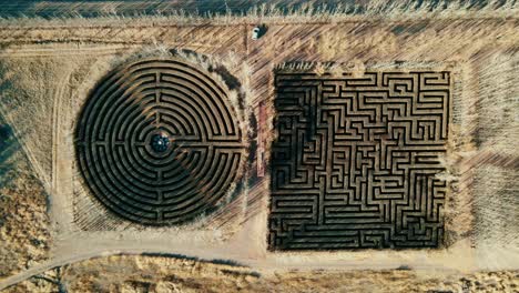 Drone's-eye-view-of-two-labyrinths-in-the-middle-of-the-desert-in-Malargüe,-Mendoza