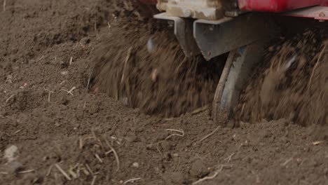 Garden-Rotavator-In-Action-Tilling-Soil.-closeup-shot