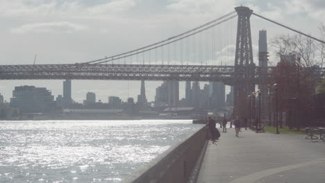 Bright-Afternoon-View-Along-East-River-Waterfront-With-Williamsburg-Bridge-In-Background
