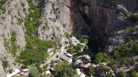 Aerial-Overhead-View-Of-Blagaj-Tekija,-A-Cliffside-Monastery-In-Bosnia-and-Herzegovina