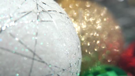 Christmas-decoration,-colorful-crystal-ornaments-gold,-blue,-green,-red-and-big-white-ball,-new-year-decorated,-shiny-lights,-close-up-Macro-tilt-up-4K-video,-beautiful-depth-of-field,-bokeh-light
