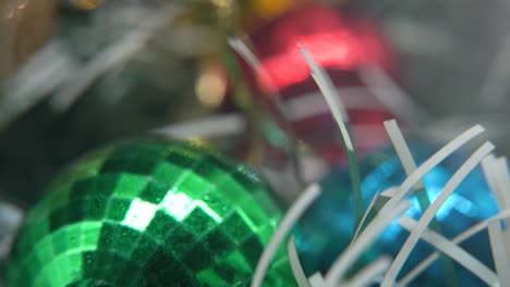 Christmas-decoration,-colorful-crystal-ornaments-balls,-blue-green-white-gold-colors,-new-year-decorated,-shiny-lights,-cinematic-close-up-Macro-tilt-up-4K-video