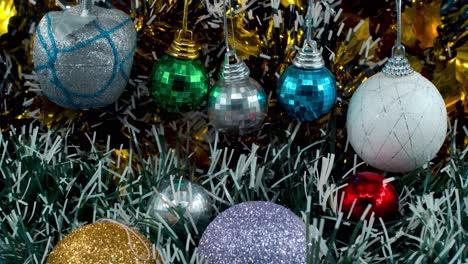 Beautiful-Christmas-decoration,-colorful-hanging-ornaments,-blue-green-white-gold-colors,-new-year-decorated,-shiny-lights,-cinematic-close-up-tilt-up-4K-video