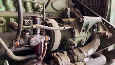 Old-and-dirty-industrial-machine-with-oil-seeping-into-the-engine-body