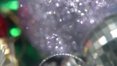 Christmas-holiday-decoration,-colorful-crystal-ornaments-colorful-balls-on-a-360-rotating-stand-new-year-decorated,-shiny-lights,-cinematic-close-up-Macro-tilt-up-4K-video,-beautiful-depth-of-field