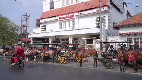 Rows-of-horse-drawn-carriages-parked-on-the-side-of-Malioboro-road