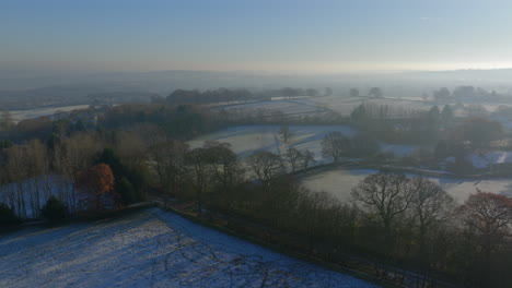 Establishing-Aerial-Drone-Shot-Over-Fields-and-Trees-in-Winter-on-Frosty-Morning-in-Yorkshire-UK