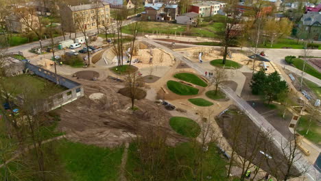 Aerial-drone-rotating-shot-over-kids-playground-under-construction-in-city-park-at-daytime