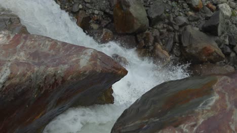 Closeup-shot-of-water-flowing-through-rocks,-water-erosion,-slow-motion