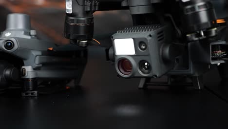 Close-up-of-folded-drone-gimbal-cameras-with-different-lenses-at-showcase
