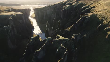 Fjaðrárgljúfur,-famous-river-gorge,-panorama-valley-in-Iceland,-aerial-tilt-up