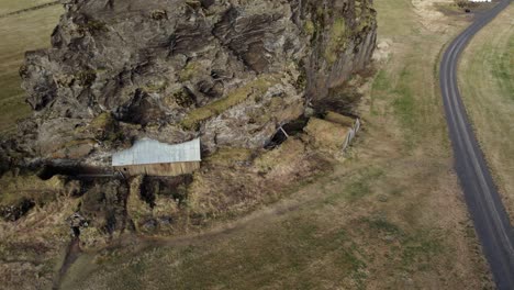 Old-Icelandic-legend,-elf-huts-on-mountain-rock-Drangurinn-in-Eyjafoll,-aerial