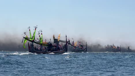 Fishing-boats-during-Patik-Laut-festival-in-Banyuwangi,-Jawa,-Indonesia-covered-in-smoke-exhaust