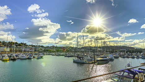 Harbor-of-yachts-at-Guernsey-island-on-sunny-day,-time-lapse-view