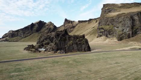 Aerial-backwards-Drangurinn-Rock,-Icelandic-folklore,-famous-sightseeing
