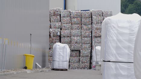 Waste-plastic-bottles-ballots-outside-recycling-facility-plant-company