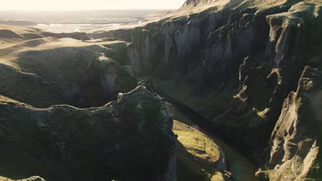 Cinematic-aerial-backward-establisher,-famous-river-canyon-in-Iceland,-sunrise