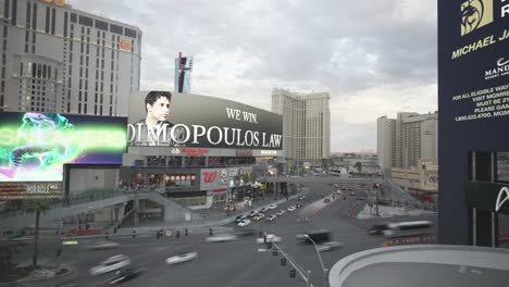 Time-lapse-of-big-large-LED-Billboard-walls-in-the-center-of-Las-Vegas-Nevada-marketing-ads-along-car-traffic-and-traffic-lights