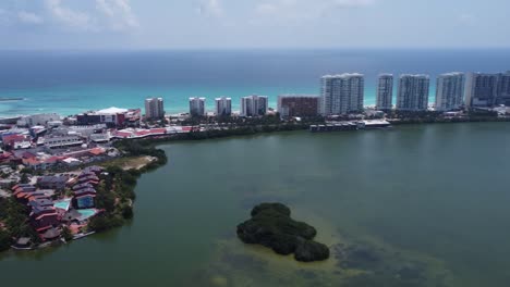 Aerial-tour-of-Cancun-hotel-zone-with-blue-Caribbean-sea-and-Nichupte-Lagoon,-Mexico