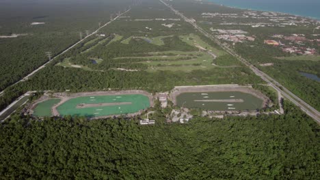 Aerial-massive-waterpark-in-Riviera-Maya,-Mexico-near-coast-in-deep-forest