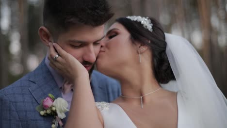 Wedding-couple-making-a-kiss.-Lovely-groom-and-bride.-Happy-family