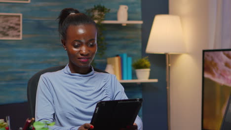 African-american-businesswoman-taking-break-using-tablet