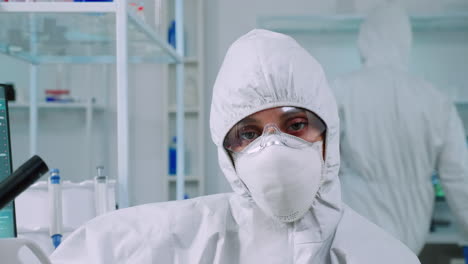 Portrait-of-tired-scientist-in-coverall-looking-at-camera