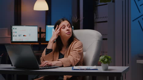 Overworked-exhausted-businesswoman-working-in-startup-office-checking-management-strategy