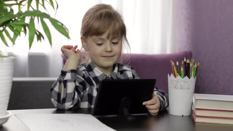 Girl-learning-online-lessons-using-digital-tablet-computer.-Distance-education