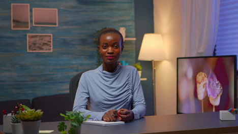 African-freelancer-working-from-home-talking-on-camera