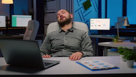 Workaholic-businessman-slepping-on-chair-in-business-company-office-late-at-night