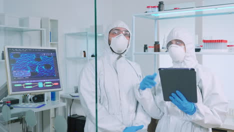 Team-of-scientists-in-ppe-suit-using-virtual-reality-in-chemistry-lab
