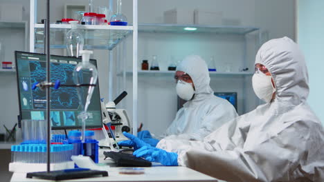 Scientists-in-protection-suits-working-in-chemical-lab