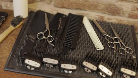 Shaving-set-with-equipment,-tools-and-foam,-barber-shop,-scissors,-comb-on-desk