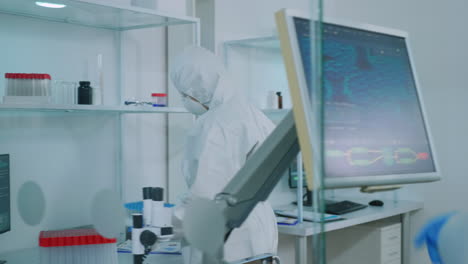 Biochemists-nurse-in-protection-suit-bringing-test-tubes