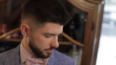 Groom-with-a-black-beard-looks-at-the-camera.-Businessman.-Pink-bow-tie