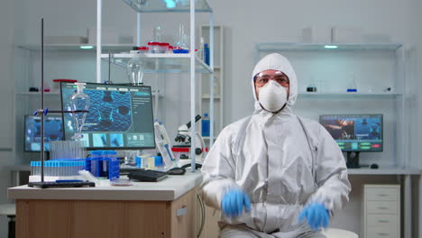 Lab-technician-in-ppe-suit-working-with-virtual-reality